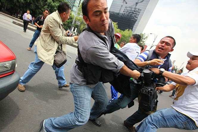 A base de golpes los manifestantes agredieron al camarógrafo Miguel Andrade (Cortesía Israel Rosas) A base de golpes los manifestantes agredieron al camarógrafo Miguel Andrade (Cortesía Israel Rosas)