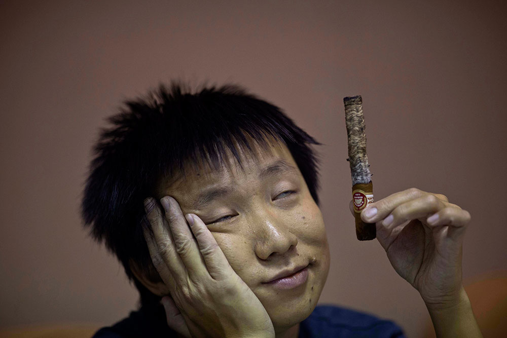 Bien fumado. Uno de los participantes en una competencia para ver quién logra la ceniza de un puro más larga sostiene su habano en La Habana, Cuba.